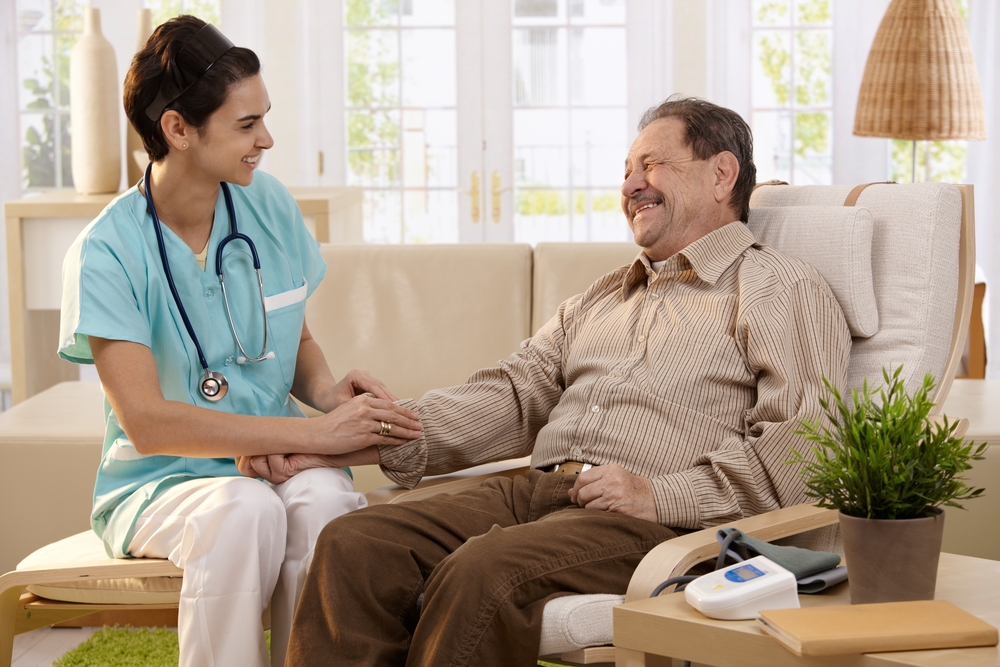 Nurse measuring the blood pressure of a senior resident